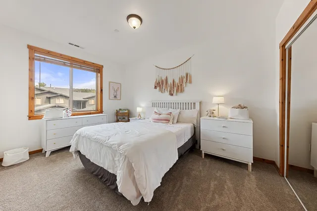 a bed room with a bed and a window