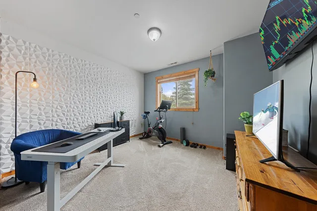 a room with gym equipment and a flat screen tv