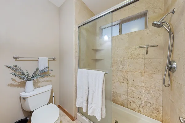 a bathroom with a toilet and a shower