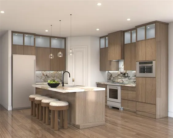 a large kitchen with stainless steel appliances a large counter top