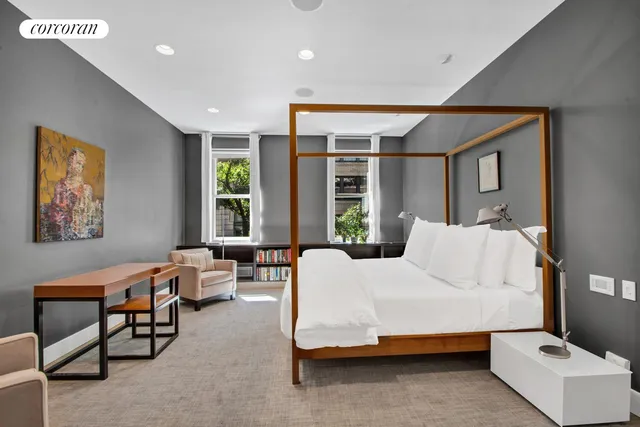 a bathroom with a tub a sink and mirror