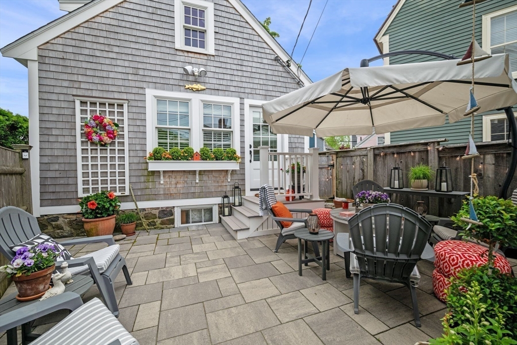 31 Franklin Street Marblehead, MA 01945 - Photo 33 of 35 a view of a patio with a table and chairs under an umbrella