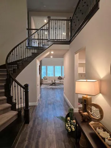 a view of entryway and hall with wooden floor