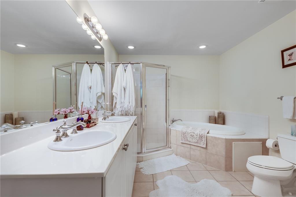 3275 Lenox Road Northeast, Unit 108 Atlanta, GA 30324 - Photo 9 of 22 a bathroom with a sink toilet and shower
