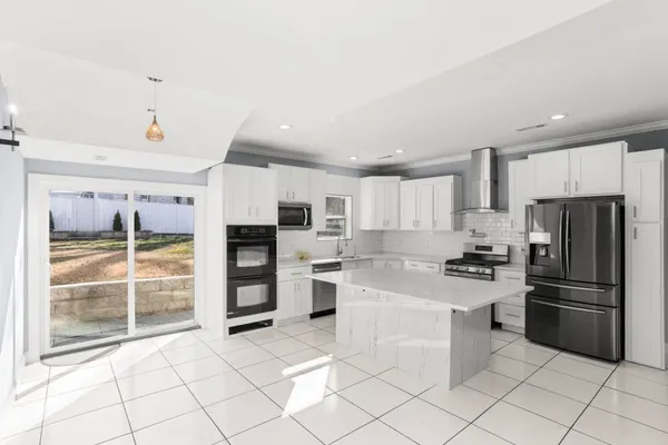 a kitchen with stainless steel appliances a refrigerator sink and microwave