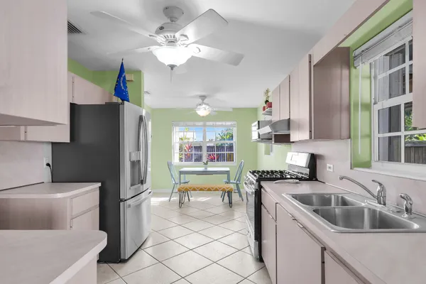 a kitchen with a sink cabinets and appliances