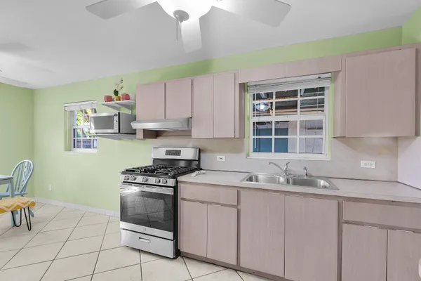 a kitchen with granite countertop a stove a sink and a cabinets