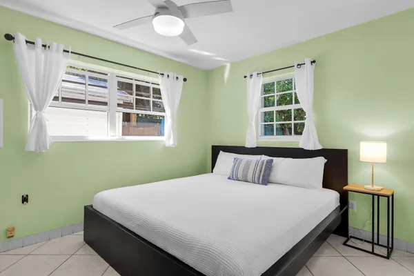 a bedroom with a large bed and a window