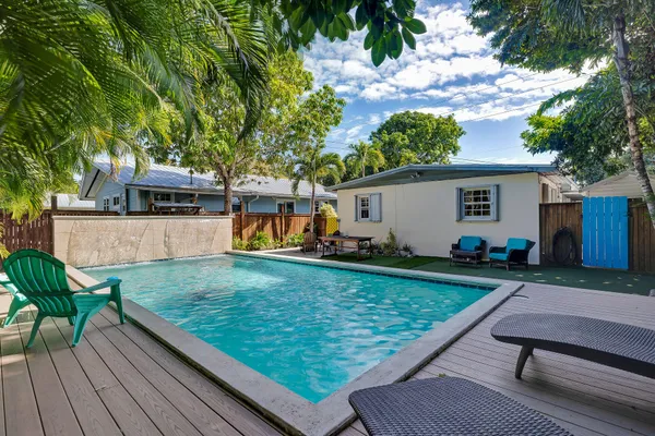 a view of a backyard with a sitting area