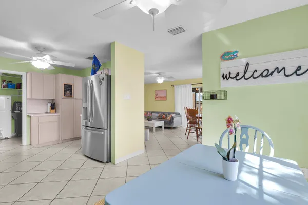 a kitchen with refrigerator and white cabinets