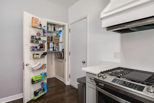 a view of kitchen stove and refrigerator