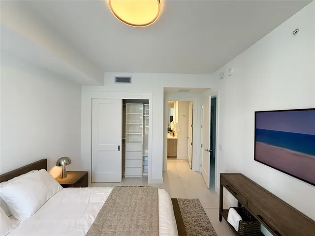 a bedroom with bed and a table