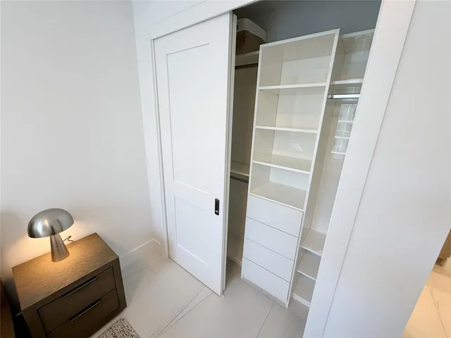 a room with a closet and washing machine