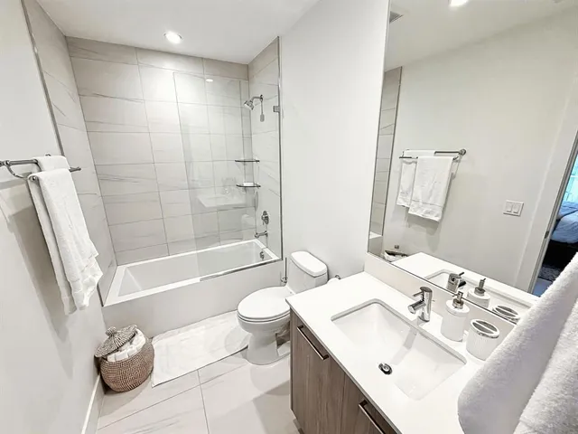 a bathroom with a sink toilet tub and shower