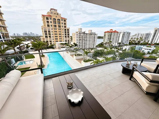 a view of roof deck with seating space and city view