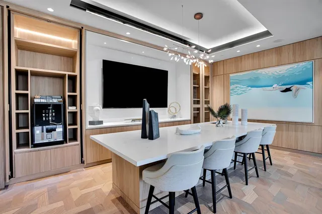 a living room with furniture a chandelier and a large window