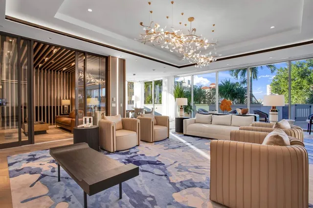 a living room with furniture pool table and flat screen