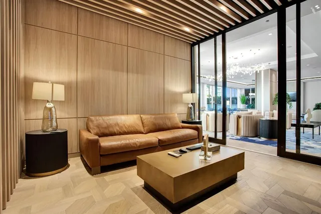 a room with stainless steel appliances kitchen island granite countertop a table and chairs in it