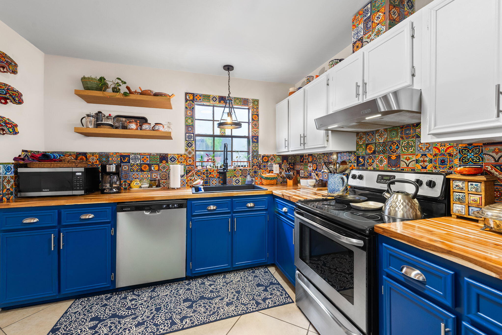 a kitchen with stainless steel appliances granite countertop a stove a sink dishwasher and cabinets with wooden floor