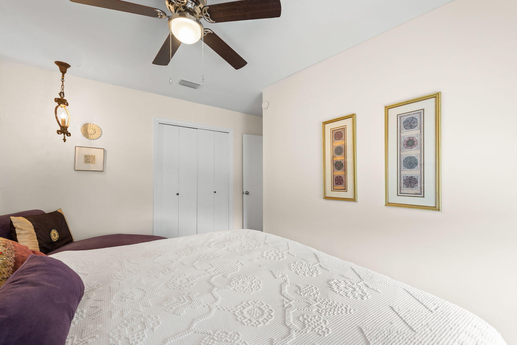 37 12th Street, Unit V126 Shalimar, FL 32579 - Photo 13 of 26 a bedroom with a bed and a chandelier