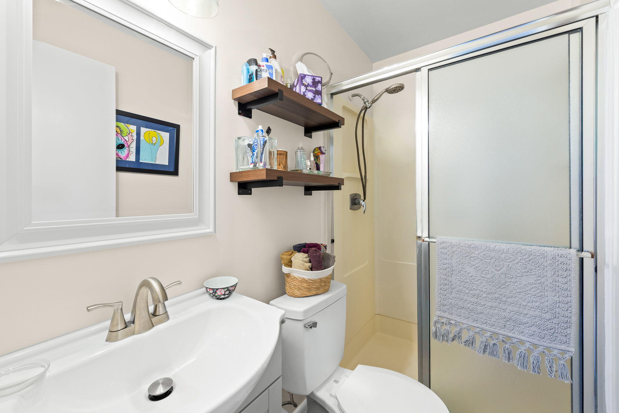 37 12th Street, Unit V126 Shalimar, FL 32579 - Photo 16 of 26 a bathroom with a sink mirror vanity and toilet