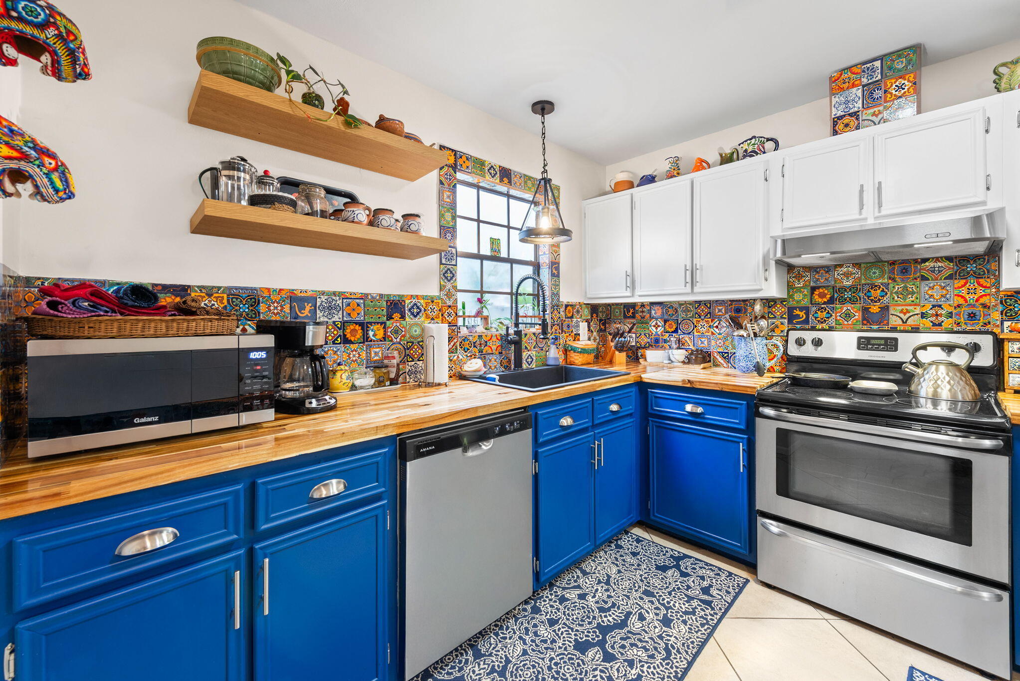 37 12th Street, Unit V126 Shalimar, FL 32579 - Photo 5 of 26 a kitchen with granite countertop stainless steel appliances and wooden cabinets