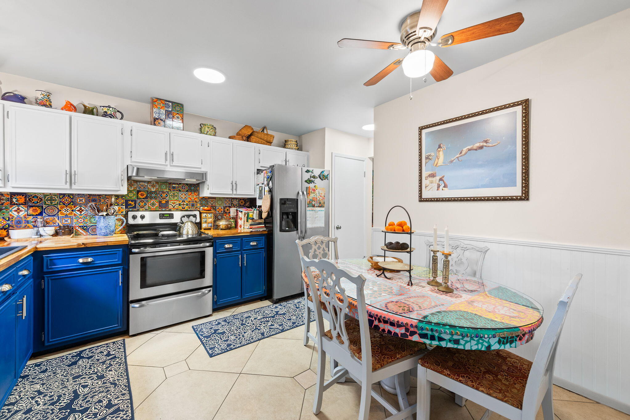 37 12th Street, Unit V126 Shalimar, FL 32579 - Photo 6 of 26 a kitchen with stainless steel appliances kitchen island granite countertop a refrigerator a stove a sink a dining table and chairs with wooden floor