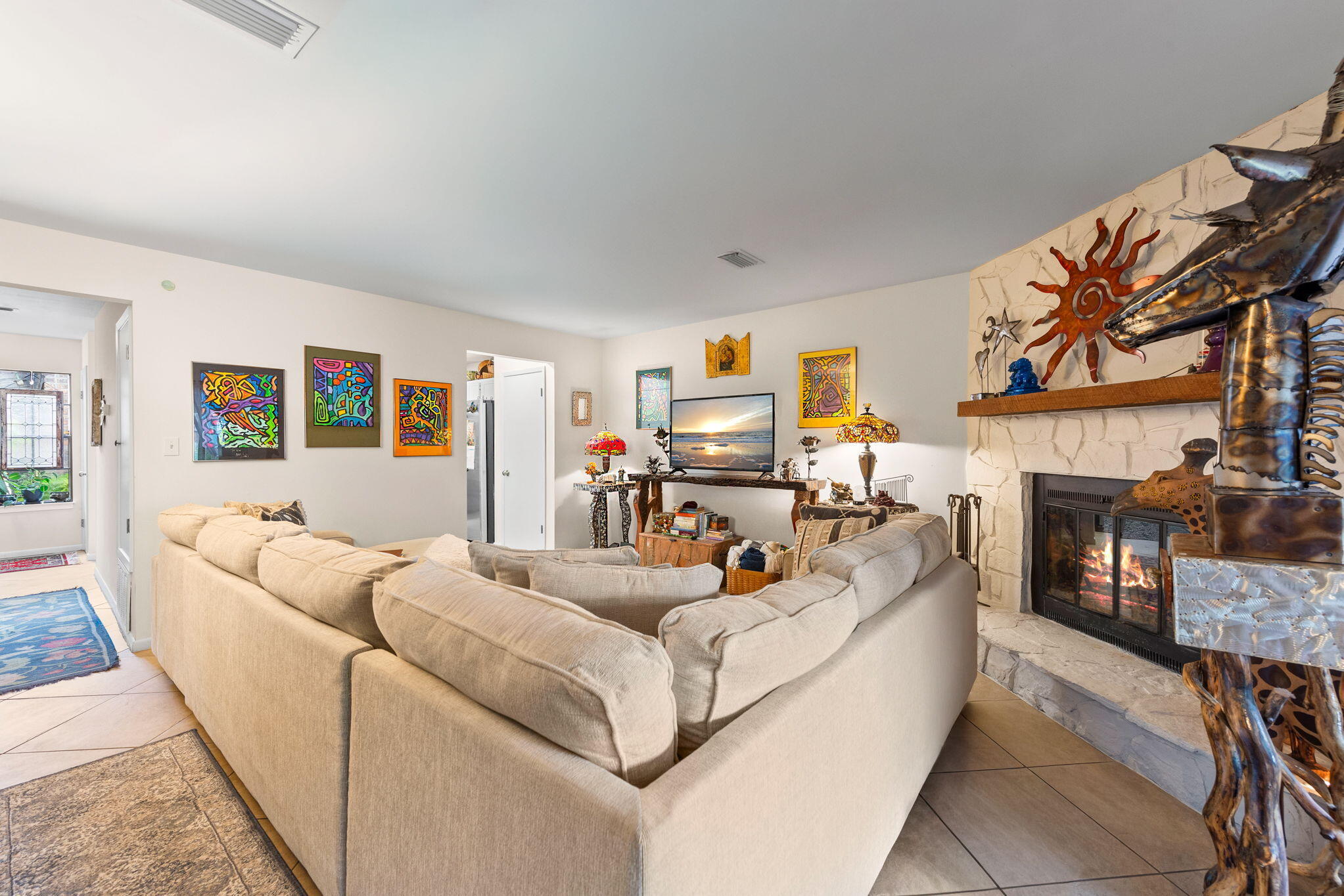 37 12th Street, Unit V126 Shalimar, FL 32579 - Photo 10 of 26 a living room with furniture a fireplace and a flat screen tv