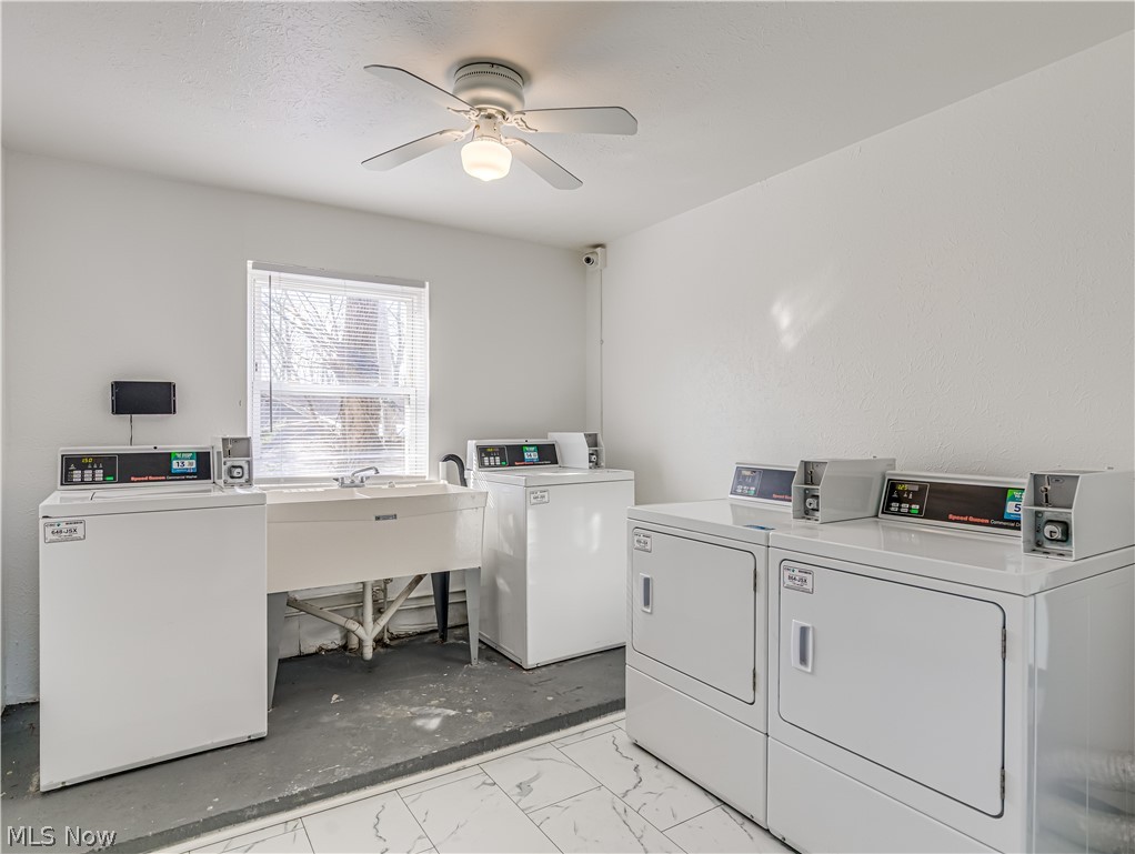 5382 Lee Road, Unit 204 Maple Heights, OH 44137 - Photo 15 of 15 Community laundry with washing machine and clothes dryer and a ceiling fan