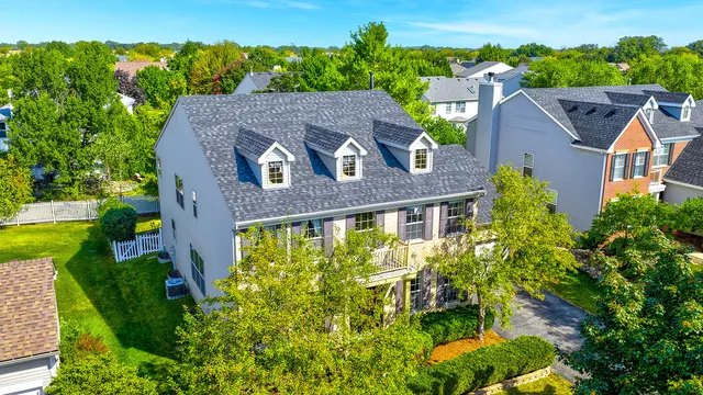 an aerial view of a house with a yard and a garden