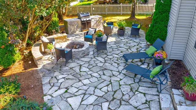 a view of a chairs and table in backyard