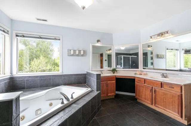 a spacious bedroom with a bed and a window