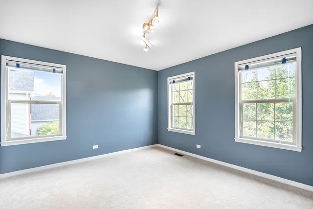 a view of a hallway with wooden floor and windows