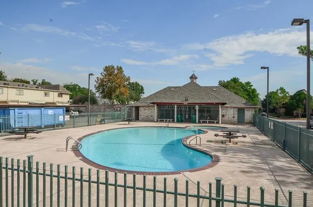 a view of a house with pool and sitting area
