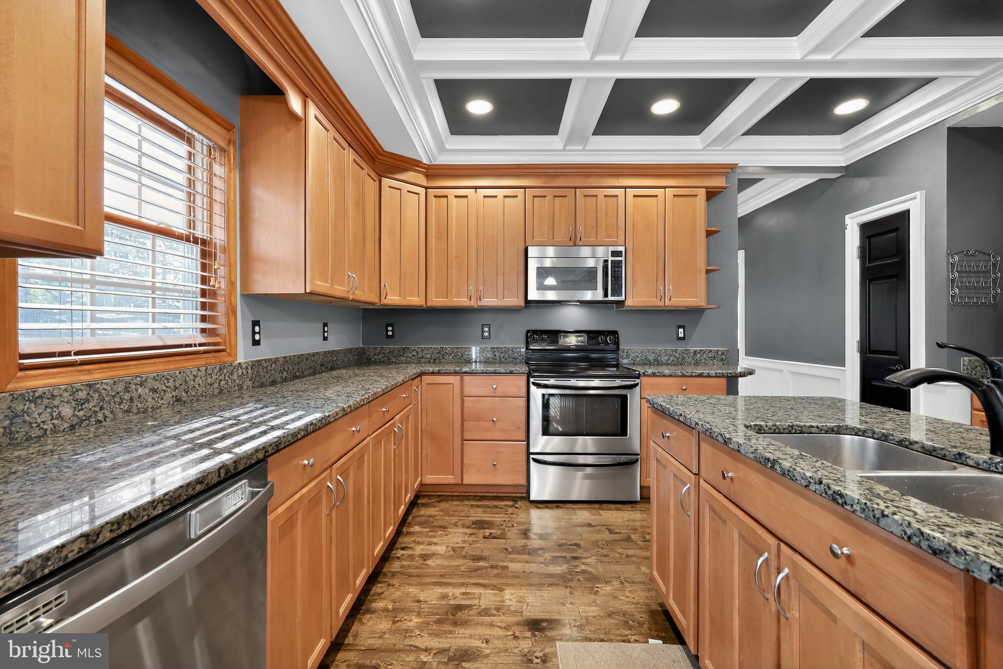 7328 Rocky Road Gaithersburg, MD 20882 - Photo 11 of 33 a kitchen with stainless steel appliances granite countertop a sink window and cabinets