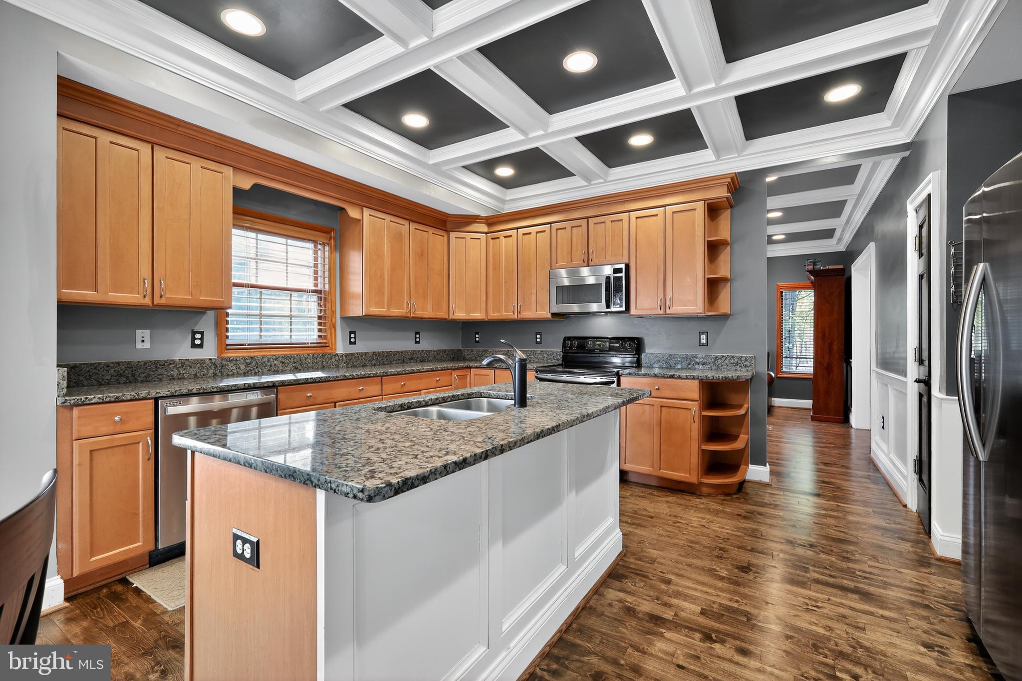 7328 Rocky Road Gaithersburg, MD 20882 - Photo 12 of 33 a kitchen with stainless steel appliances granite countertop a stove a sink dishwasher a refrigerator and wooden cabinets with wooden floor