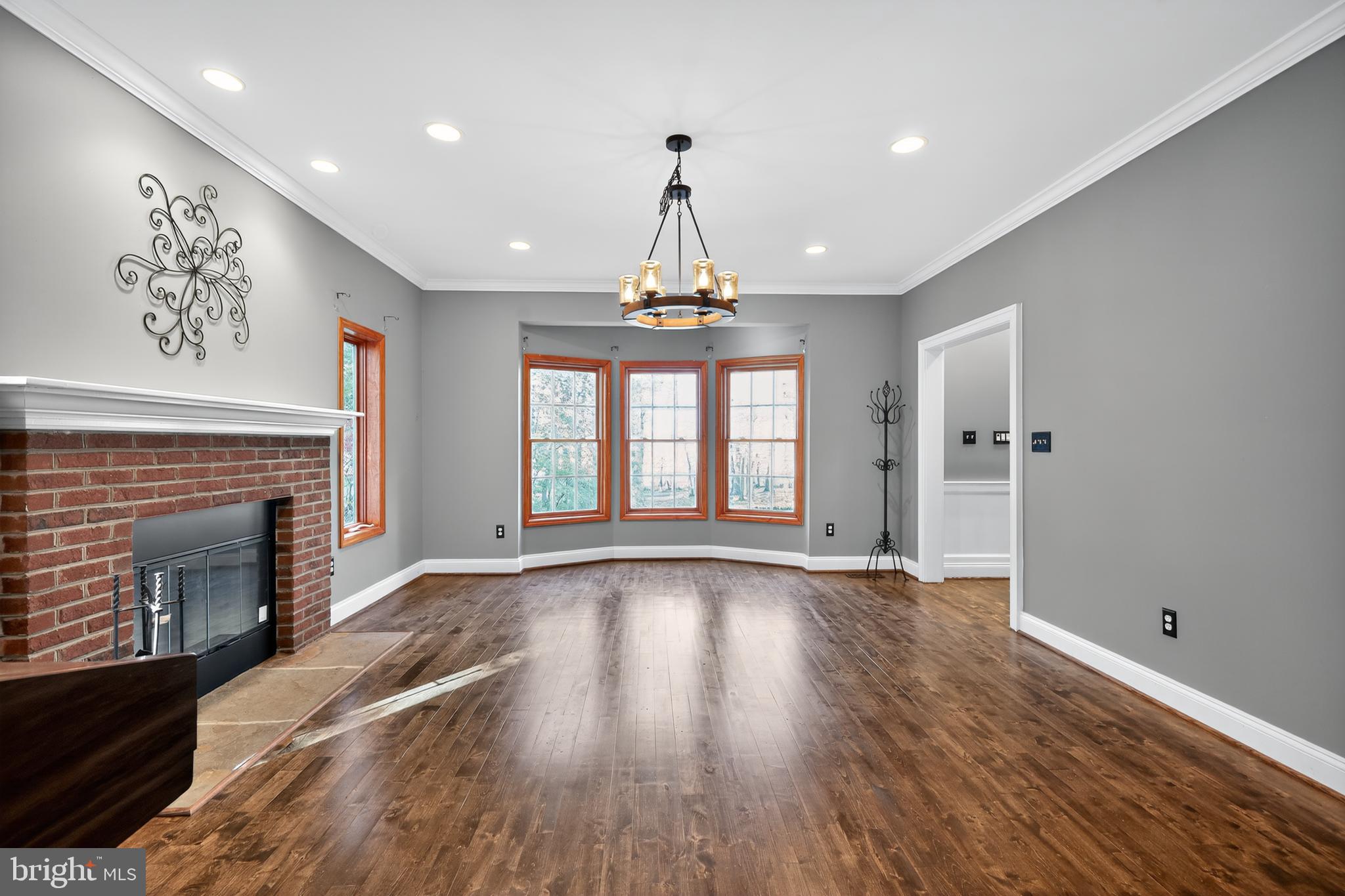 7328 Rocky Road Gaithersburg, MD 20882 - Photo 15 of 33 a view of an empty room with wooden floor fireplace and a window