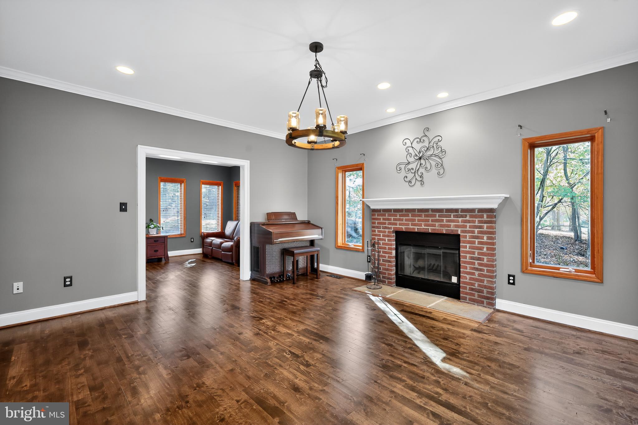 7328 Rocky Road Gaithersburg, MD 20882 - Photo 16 of 33 a living room with furniture a fireplace and a chandelier