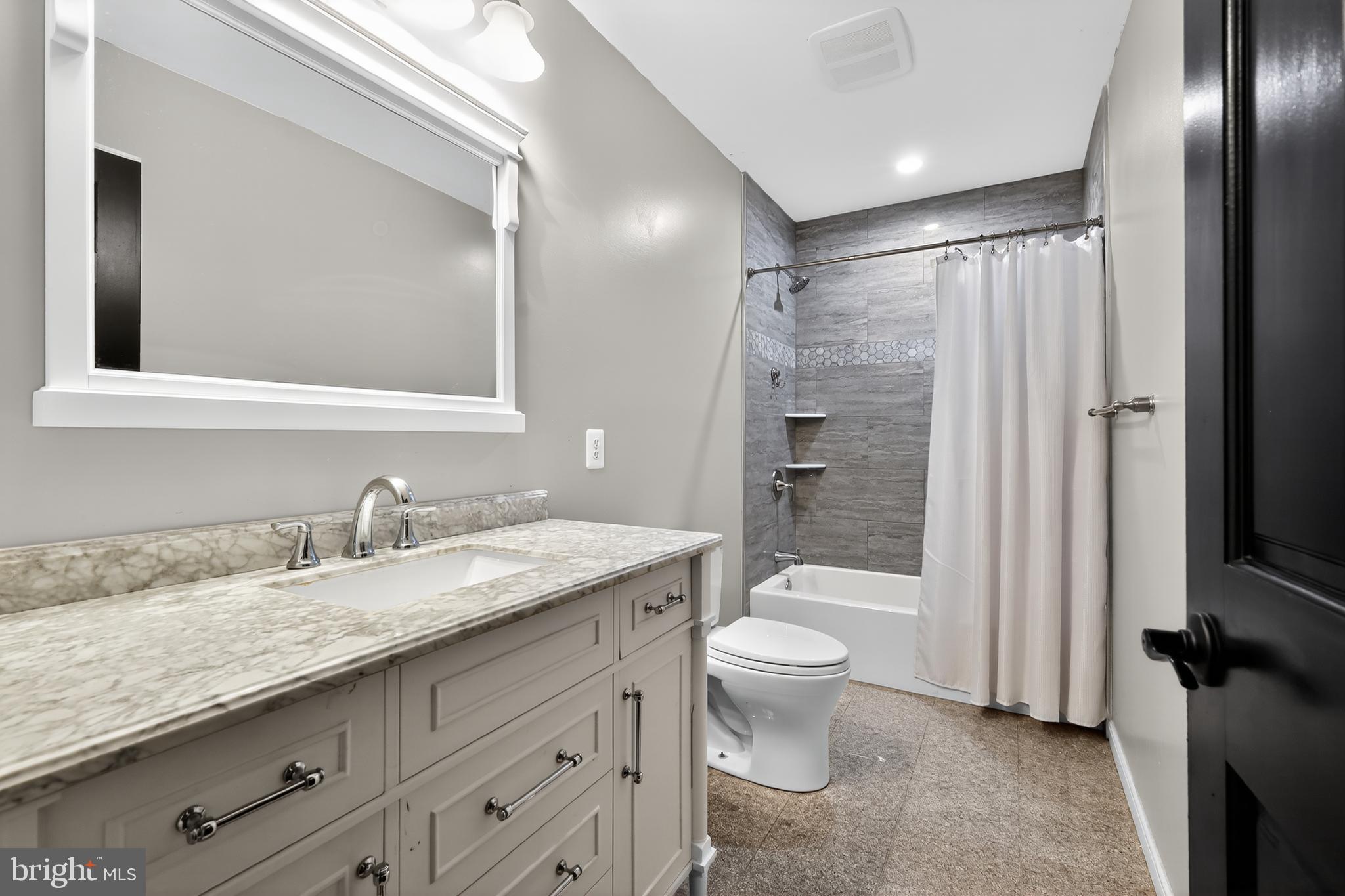 7328 Rocky Road Gaithersburg, MD 20882 - Photo 24 of 33 a bathroom with a granite countertop sink toilet and shower