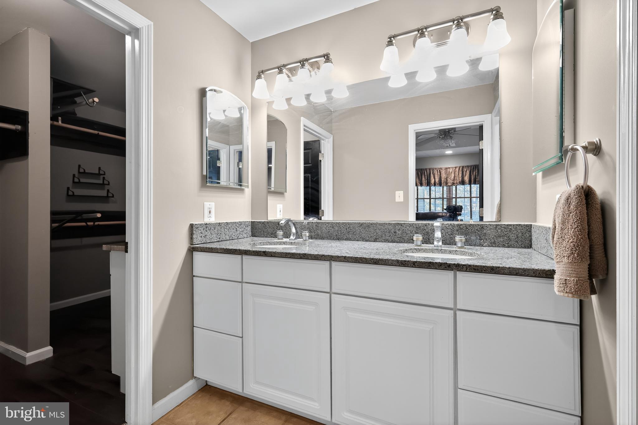 7328 Rocky Road Gaithersburg, MD 20882 - Photo 25 of 33 a bathroom with a granite countertop sink and a mirror