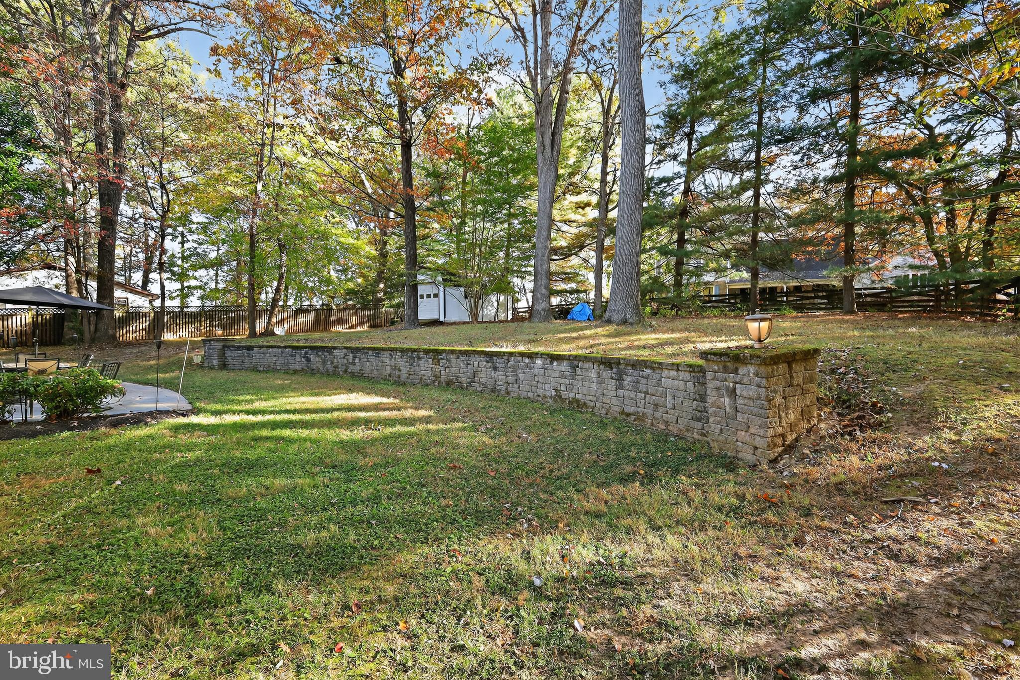 7328 Rocky Road Gaithersburg, MD 20882 - Photo 6 of 33 a view of a swimming pool with a yard and large trees
