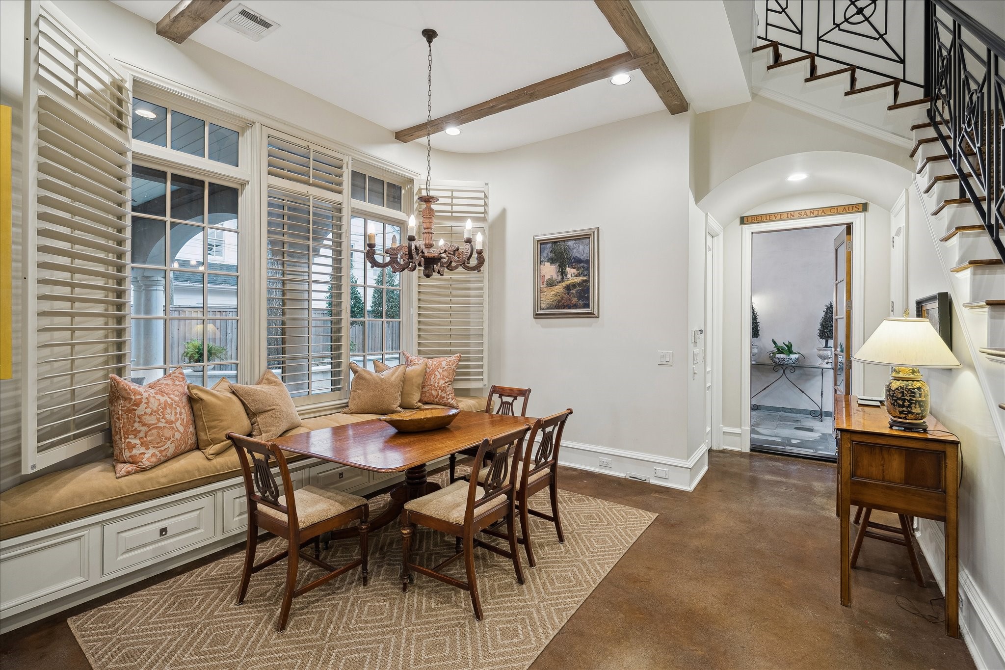 3109 Locke Lane Houston, TX 77019 - Photo 18 of 50 Thoughtfully tucked beside the kitchen and living spaces, the breakfast room invites relaxed mornings with built-in window seating and abundant natural light. Plantation shutters, rich hardwood flooring, and a statement chandelier add warmth and character to this intimate dining setting.