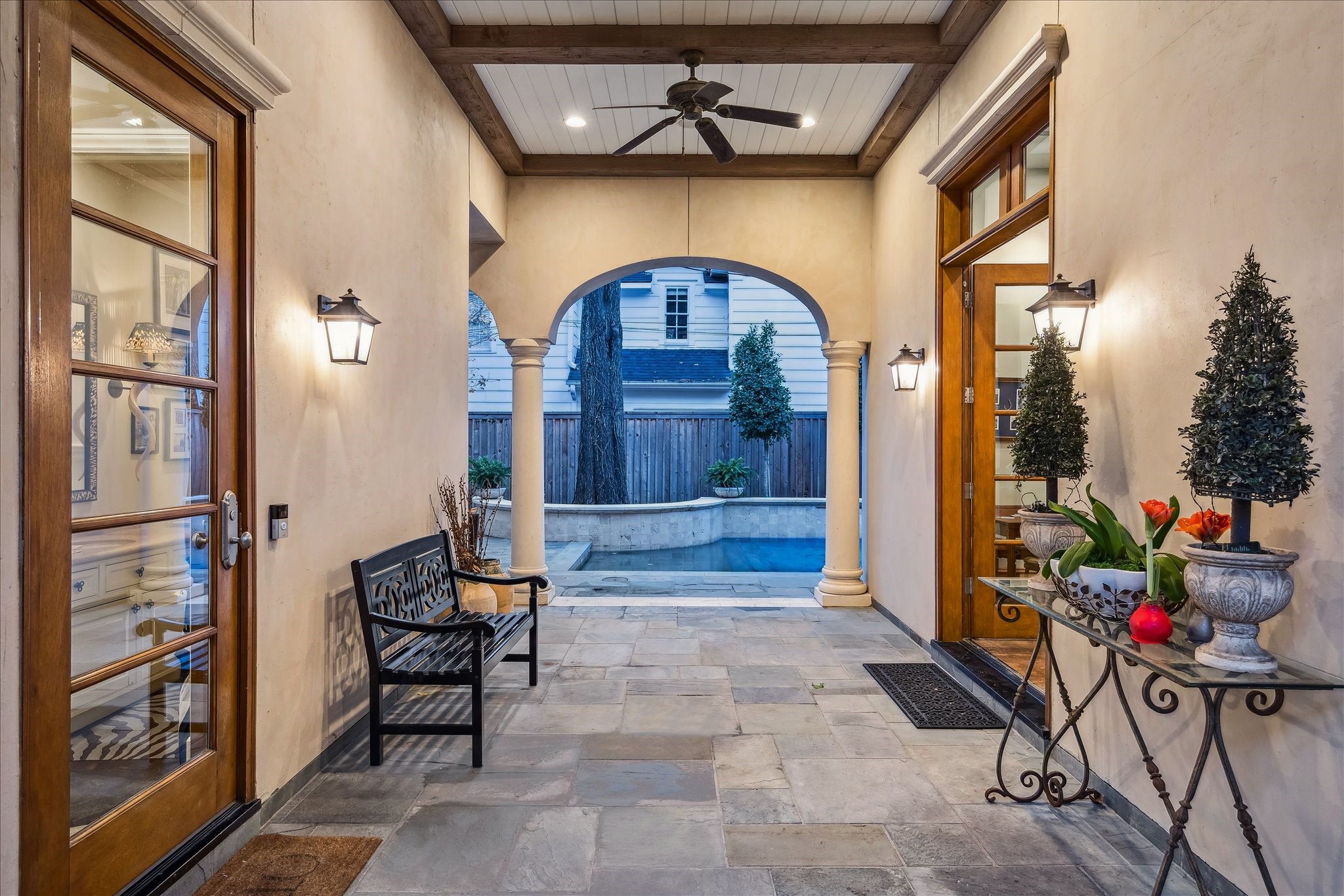 3109 Locke Lane Houston, TX 77019 - Photo 38 of 50 A covered patio thoughtfully connects the main house to the garage, guest quarters, and first-floor game room/flex space. Featuring ambient lighting, a beamed ceiling, and a ceiling fan, it provides a stylish and functional transition for indoor-outdoor living.