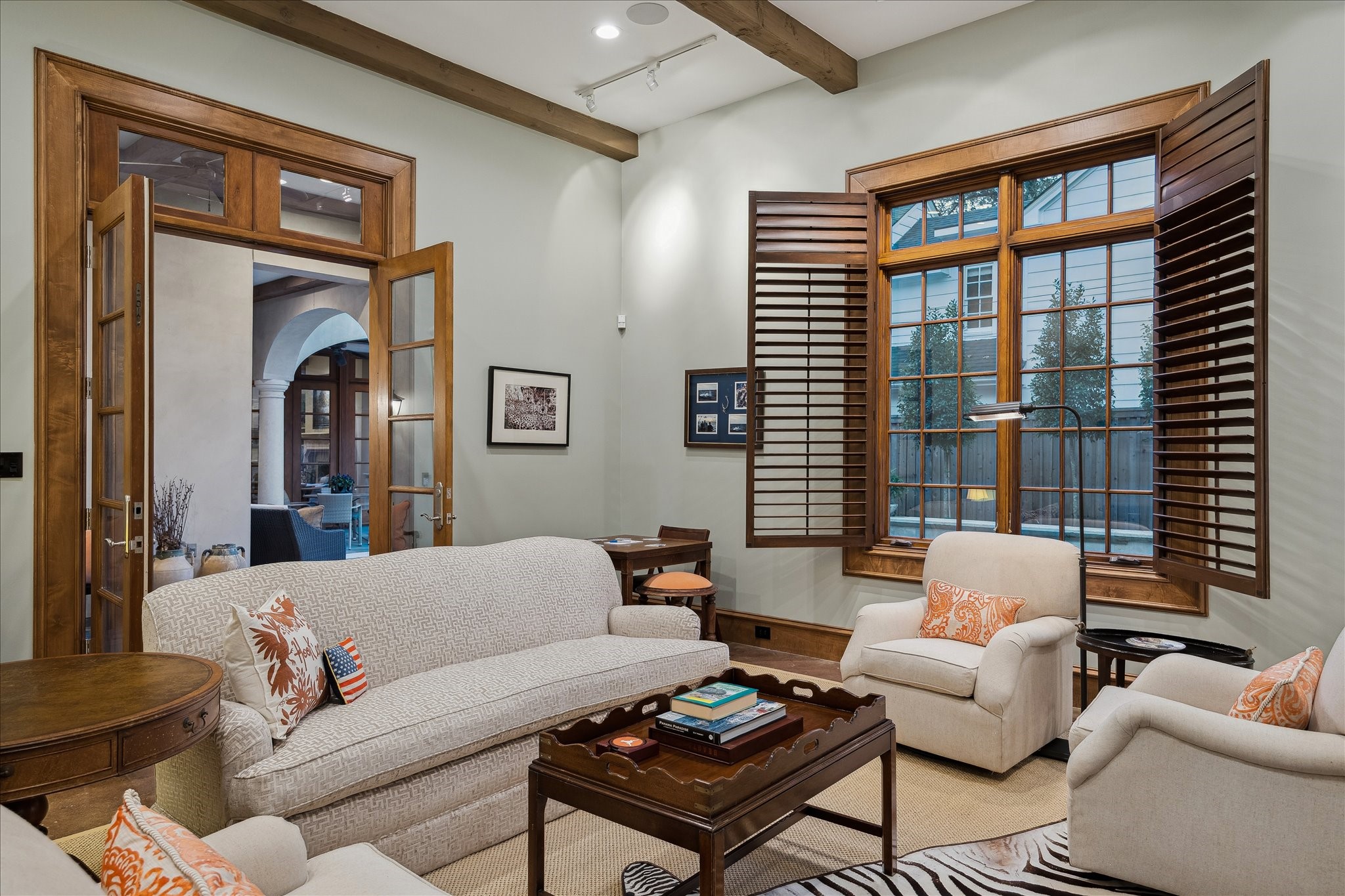 3109 Locke Lane Houston, TX 77019 - Photo 42 of 50 A detached first-floor retreat designed for flexibility, complete with rich wood paneling, exposed beams, and a stone fireplace. Built-in cabinetry, media storage, and warm hardwood flooring make it an ideal game room, media room, or private lounge.