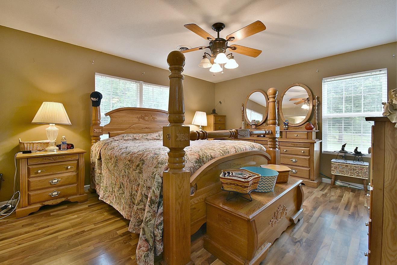 950 Chestnut Grove Road Dandridge, TN 37725 - Photo 13 of 25 a bedroom with a bed and a chandelier