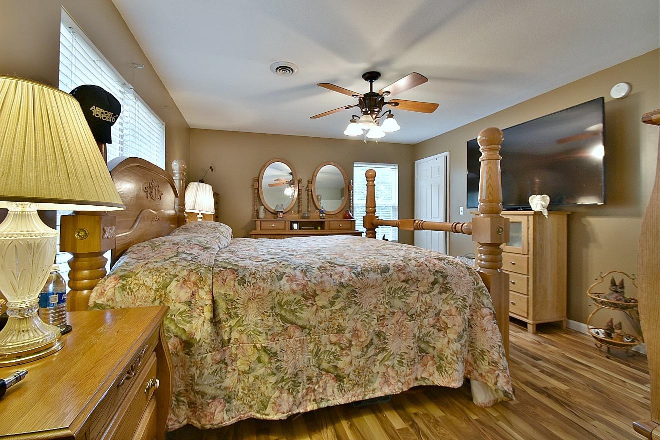 950 Chestnut Grove Road Dandridge, TN 37725 - Photo 14 of 25 a spacious bedroom with a bed a dresser and wooden floor