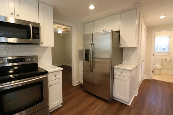a kitchen with stainless steel appliances a refrigerator stove and microwave