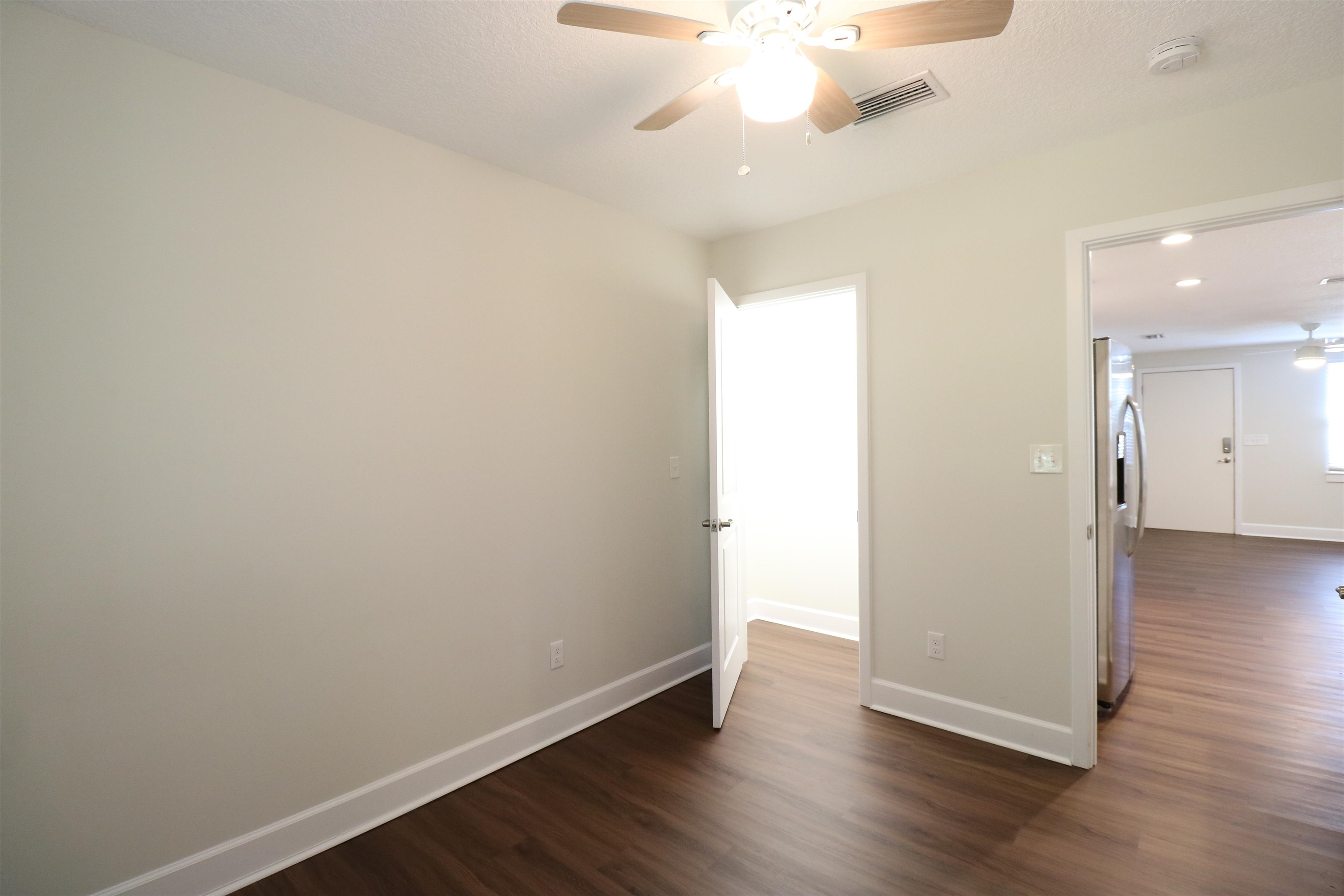 96 Barbarosa Street St. Augustine, FL 32086 - Photo 10 of 17 an empty room with wooden floor and a chandelier fan