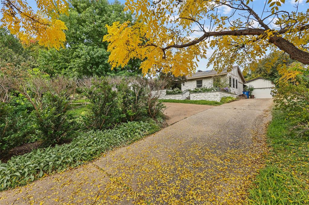 13215 Copenhill Road Dallas, TX 75240 - Photo 1 of 1 a view of a road with plants and large trees