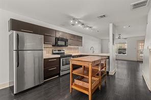 1101 Grove Boulevard, Unit 206 Austin, TX 78741 - Photo 19 of 23 a kitchen with a refrigerator sink and cabinets